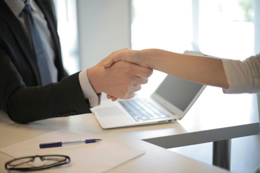Agent and client shaking hands over a signed policy